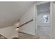Hallway with wooden handrail leading to a bedroom with a window at 2626 E 18Th St, Indianapolis, IN 46218