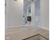 Hallway with hardwood floors leading to a tiled bathroom and carpeted room at 2626 E 18Th St, Indianapolis, IN 46218