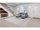 Bright living room featuring a modern staircase, comfortable seating, and a stylish area rug at 2626 E 18Th St, Indianapolis, IN 46218