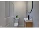 Neat powder room with modern fixtures including a floating sink and toilet at 2626 E 18Th St, Indianapolis, IN 46218