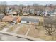Aerial view of a single story home with a driveway and a bright red front door at 2714 Manlove Ave, Indianapolis, IN 46218