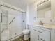Bright bathroom featuring a tiled shower with a seat, a vanity with countertop and soft-close drawers at 2714 Manlove Ave, Indianapolis, IN 46218
