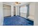 Cozy bedroom featuring blue carpet, a built-in closet, and natural light from the window at 2714 Manlove Ave, Indianapolis, IN 46218