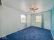 Bedroom with 2 windows, blue carpet and walls, and a ceiling fan at 2714 Manlove Ave, Indianapolis, IN 46218