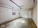 Clean garage space with a functioning garage door opener and side entry door at 2714 Manlove Ave, Indianapolis, IN 46218