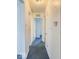 Hallway featuring carpet, neutral paint, with three doorways leading to other rooms at 2714 Manlove Ave, Indianapolis, IN 46218