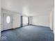 A Large living room featuring neutral paint, carpet, and a front door at 2714 Manlove Ave, Indianapolis, IN 46218