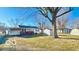 The exterior view exhibits backyard, detached garage and shed surrounded by large mature trees at 283 N Brooks St, Columbus, IN 47201
