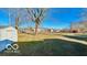 A expansive backyard includes a shed and a fence and some nice shade provided by a large tree at 283 N Brooks St, Columbus, IN 47201