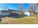 Exterior view displaying backyard, detached garage and shed in the distance at 283 N Brooks St, Columbus, IN 47201