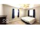 A well-lit bedroom with two windows and a ceiling fan at 283 N Brooks St, Columbus, IN 47201
