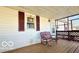 A cozy covered porch features a traditional bench seating and view to adjacent backyard at 283 N Brooks St, Columbus, IN 47201