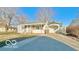 Lovely single-story home with a long concrete driveway leading to a garage, and a tidy front lawn at 283 N Brooks St, Columbus, IN 47201