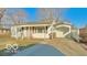 Charming single-story home with a cozy front porch, long driveway, and attached garage at 283 N Brooks St, Columbus, IN 47201