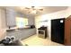 Well-lit kitchen featuring updated appliances, a stainless steel oven, and ample counter space at 283 N Brooks St, Columbus, IN 47201
