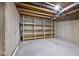 Unfinished basement with exposed ceiling and concrete floor, with shelving for storage at 2879 Bluewood Way, Plainfield, IN 46168