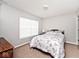 Bedroom with a window and carpet, featuring a comfortable bed and dresser at 2879 Bluewood Way, Plainfield, IN 46168