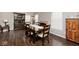 Elegant dining room with a fireplace, dark wood floors, and a stylish china cabinet at 2879 Bluewood Way, Plainfield, IN 46168