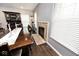 Cozy dining area with a fireplace, dark wood floors, and natural light from the window at 2879 Bluewood Way, Plainfield, IN 46168