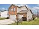 Attractive two-story home boasts a brick exterior, two-car garage, and mature landscaping at 2879 Bluewood Way, Plainfield, IN 46168