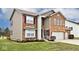 Charming two-story home with a brick facade, two-car garage, and a well-manicured front yard at 2879 Bluewood Way, Plainfield, IN 46168