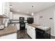 Functional kitchen with white cabinets, black appliances, and a portable island at 2879 Bluewood Way, Plainfield, IN 46168
