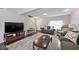 Cozy living room with dark wood floors, plush seating, and ample natural light at 2879 Bluewood Way, Plainfield, IN 46168