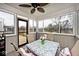 Cozy sunroom featuring large windows, a ceiling fan, and a view of the outdoor deck at 2879 Bluewood Way, Plainfield, IN 46168