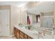 Bathroom featuring double sinks, vanity mirror, and tile flooring at 2912 Tuscarora Ln, Indianapolis, IN 46217