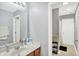 Bright bathroom featuring a sink with cabinets and a shower with curtain at 2912 Tuscarora Ln, Indianapolis, IN 46217