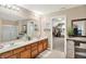 Bathroom featuring double sinks, plenty of storage, and decorative mirrors at 2912 Tuscarora Ln, Indianapolis, IN 46217