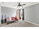 Spacious bedroom with a ceiling fan, cozy love seat, and window at 2912 Tuscarora Ln, Indianapolis, IN 46217
