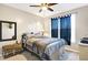 Comfortable bedroom featuring a bed, window with curtains, and mirror at 2912 Tuscarora Ln, Indianapolis, IN 46217