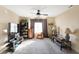 Bright bedroom featuring a ceiling fan, carpet flooring, window and television at 2912 Tuscarora Ln, Indianapolis, IN 46217