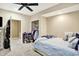 Cozy bedroom featuring a ceiling fan, a comfortable bed, and a well-organized closet space at 2912 Tuscarora Ln, Indianapolis, IN 46217