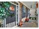 Inviting covered front porch with seasonal decor and brick accents, offering curb appeal at 2912 Tuscarora Ln, Indianapolis, IN 46217