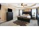 Comfortable main bedroom with a ceiling fan, carpet flooring, and king size bed at 2912 Tuscarora Ln, Indianapolis, IN 46217
