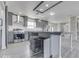 Kitchen featuring stainless steel appliances, subway tile backsplash, barn door, and gray cabinetry at 32 Downing Dr, Trafalgar, IN 46181