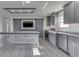 Kitchen featuring an island, stainless steel appliances, subway tile backsplash, barn door, and gray cabinetry at 32 Downing Dr, Trafalgar, IN 46181