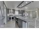 Kitchen featuring an island, stainless steel appliances, subway tile backsplash, barn door, and gray cabinetry at 32 Downing Dr, Trafalgar, IN 46181