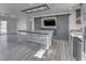 Kitchen featuring an island, stainless steel appliances, subway tile backsplash, barn door, and gray cabinetry at 32 Downing Dr, Trafalgar, IN 46181