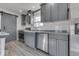 Kitchen featuring stainless steel appliances, subway tile backsplash, barn door, and gray cabinetry at 32 Downing Dr, Trafalgar, IN 46181