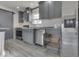 Kitchen featuring stainless steel appliances, subway tile backsplash, barn door, and gray cabinetry at 32 Downing Dr, Trafalgar, IN 46181