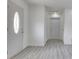 Spacious living room with light gray flooring and white walls at 32 Downing Dr, Trafalgar, IN 46181
