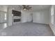 Open living room with a stone fireplace and gray carpet flooring at 32 Downing Dr, Trafalgar, IN 46181
