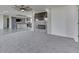 Living room with stone fireplace, gray floors, and open kitchen at 32 Downing Dr, Trafalgar, IN 46181