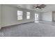 Spacious living room features gray carpeting, and a sliding glass door that leads to a deck at 32 Downing Dr, Trafalgar, IN 46181