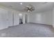 This bedroom features a ceiling fan, and neutral carpeting at 32 Downing Dr, Trafalgar, IN 46181