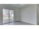 Sliding glass door that leads to a deck with white walls and gray flooring at 32 Downing Dr, Trafalgar, IN 46181
