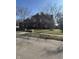 Attractive brick home framed by leafless trees and a green lawn creating a classic and inviting facade at 3695 Woodfield Pl, Columbus, IN 47203